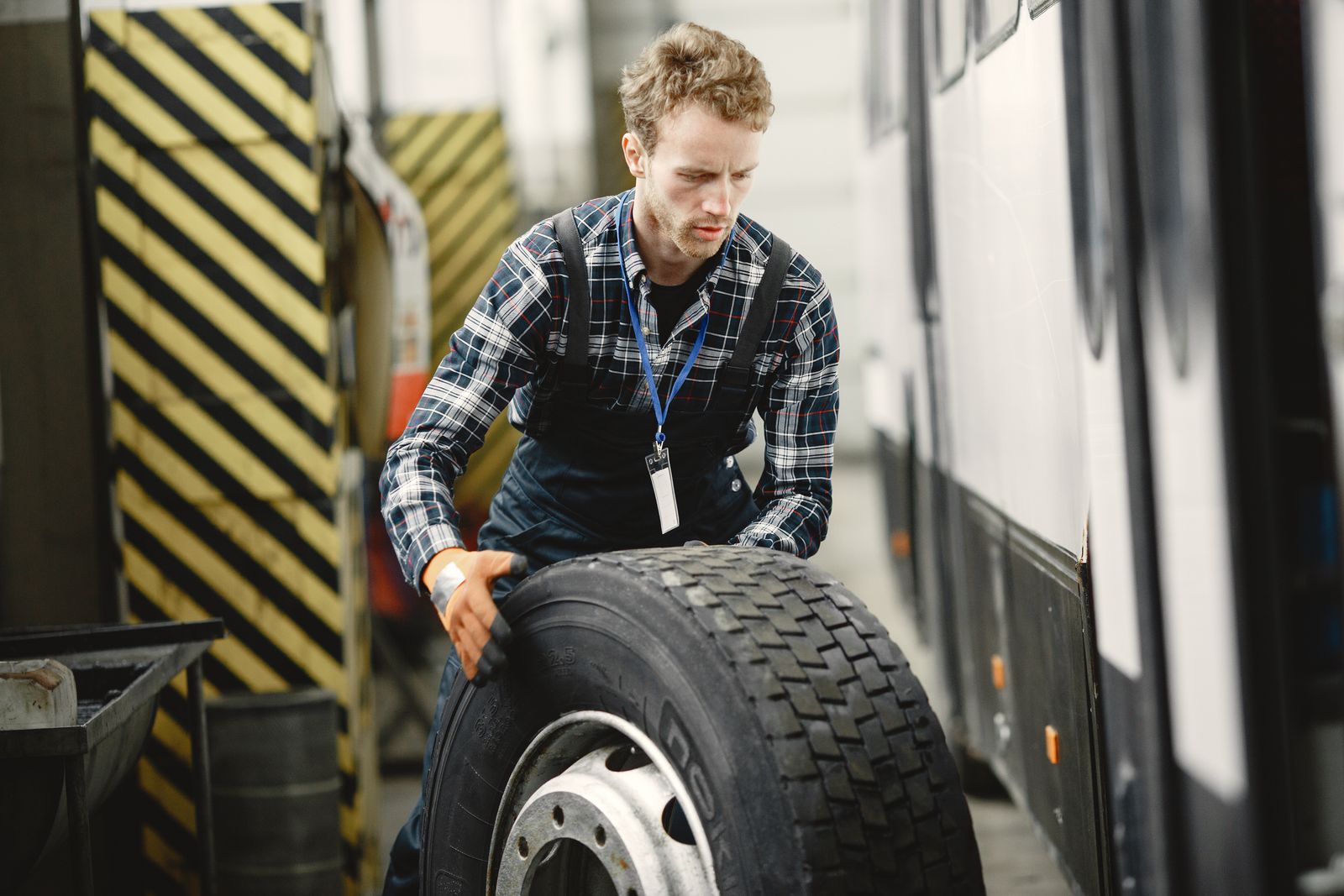 Mechanic handling a large heavy-duty truck tire